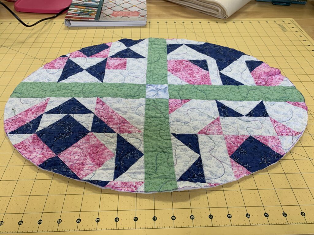 Oval table topper made from an old quilt