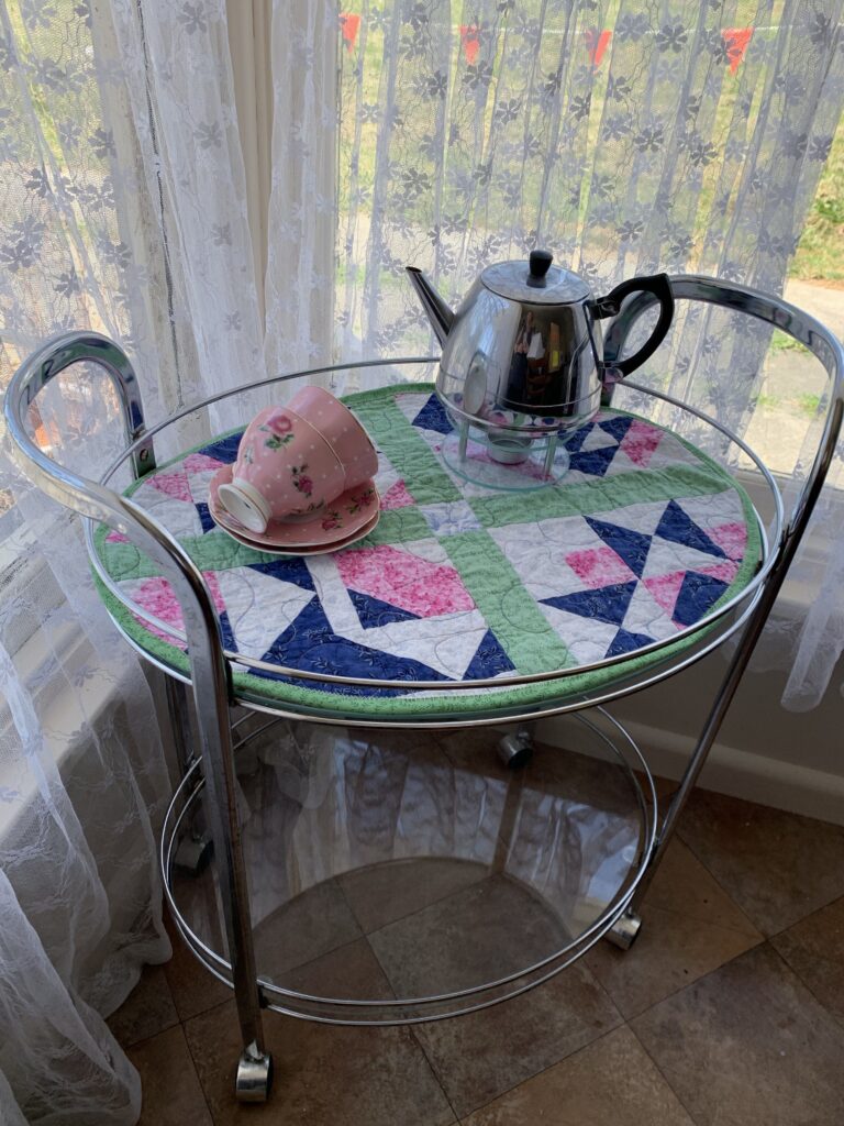 Oval table topper made from an old quilt