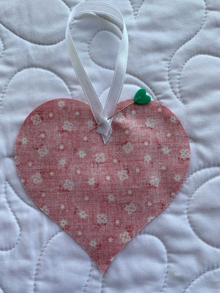 Heart with ribbon pinned to it Step 2 in How to Make an Easy Lavender Heart Sachet ~ Tutorial #lavender #lavenderflowers #lavendersachet #lavendersachets #diylavendersachet #lavendersachettutorial #lavendersachetbags #sewlavendersachet #diytutorial #sewingtutorial #diygifts 