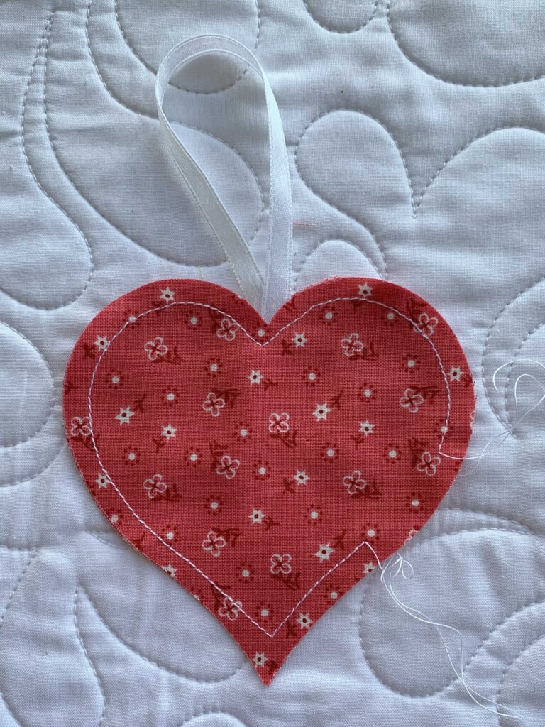 Heart sewn together with opening left to fill with lavender Step 4 in How to Make an Easy Lavender Heart Sachet ~ Tutorial #lavender #lavenderflowers #lavendersachet #lavendersachets #diylavendersachet #lavendersachettutorial #lavendersachetbags #sewlavendersachet #diytutorial #sewingtutorial #diygifts 