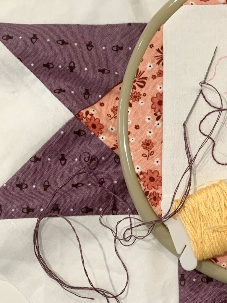 sneak peak of embroidered quilt block for 2024 block of the month