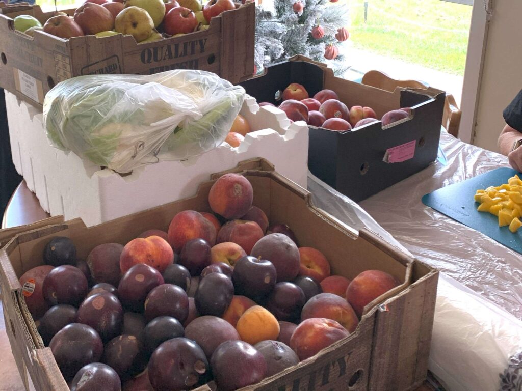 boxes of fruit on kitchen table ready to cut up and preserve