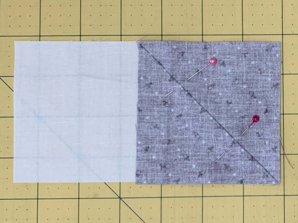 Place one of the squares, right sides together, and pin to the rectangle 